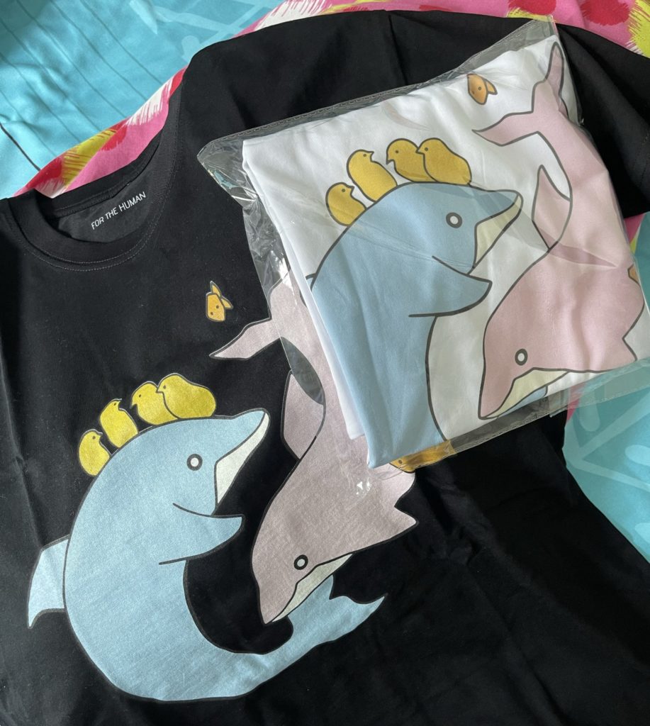 Black and white shirts with image of two dolphins